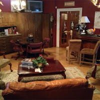 Cozy living room with wooden furniture and warm lighting.