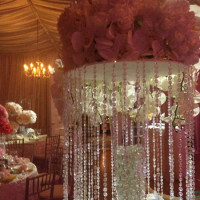Elegant floral centerpiece with cascading crystals at a luxurious event.